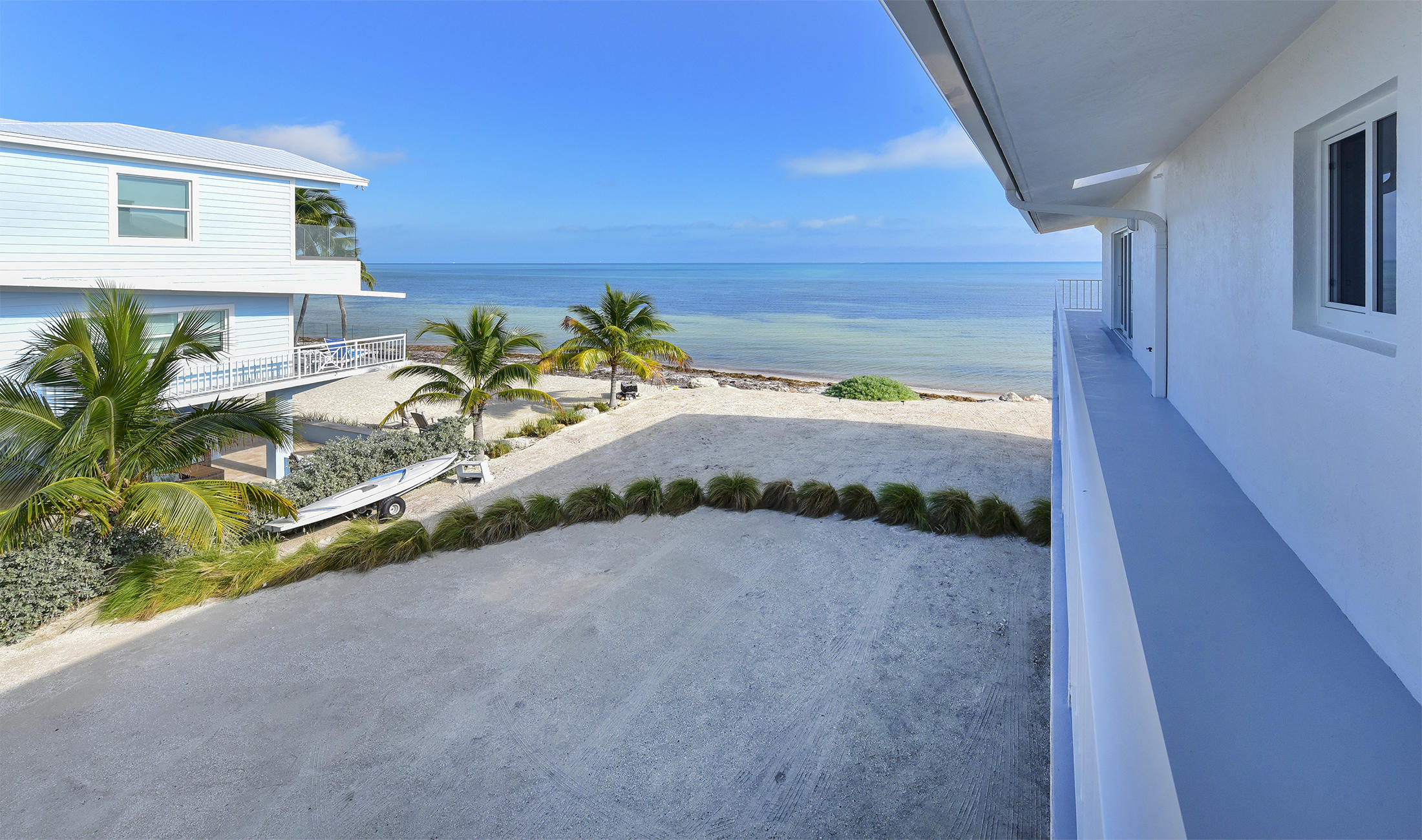 161-154 Sunset Drive Islamorada, FL 33036 - Photo 30 of 38 a view of a porch with a bench