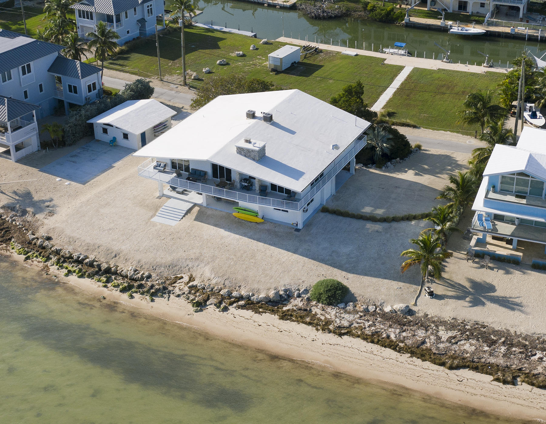 161-154 Sunset Drive Islamorada, FL 33036 - Photo 32 of 38 an aerial view of a house with a garden and lake view