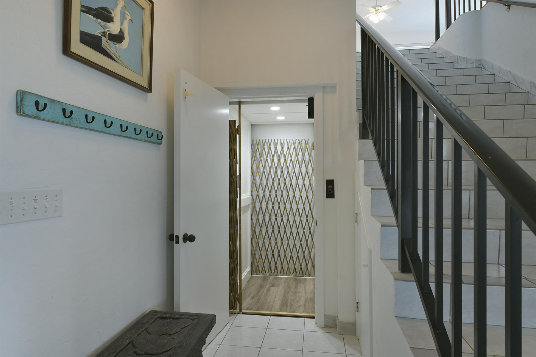 161-154 Sunset Drive Islamorada, FL 33036 - Photo 7 of 38 a view of a hallway with wooden floor and staircase