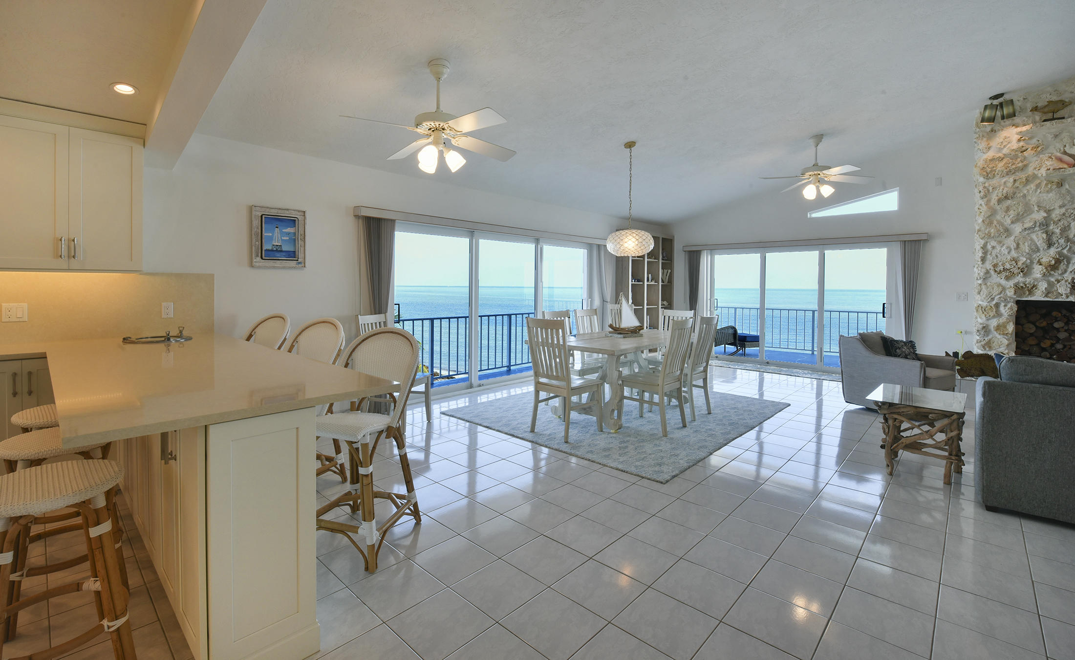 161-154 Sunset Drive Islamorada, FL 33036 - Photo 10 of 38 a view of a dining room with furniture and chandelier