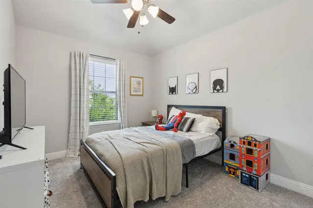 a bedroom with a bed and a tv on the dresser