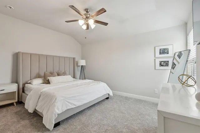 a bedroom with a bed and a table with chair