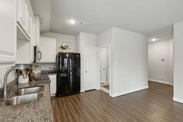 a kitchen with a refrigerator and a sink