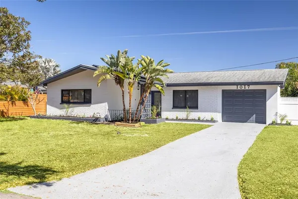 a front view of house with yard and swimming pool