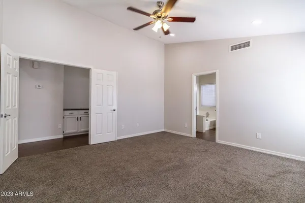 a view of empty room with ceiling fan