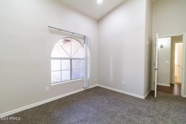an empty room with windows and closet