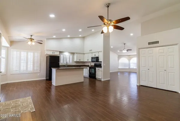 a view of kitchen with sink and refrigerator