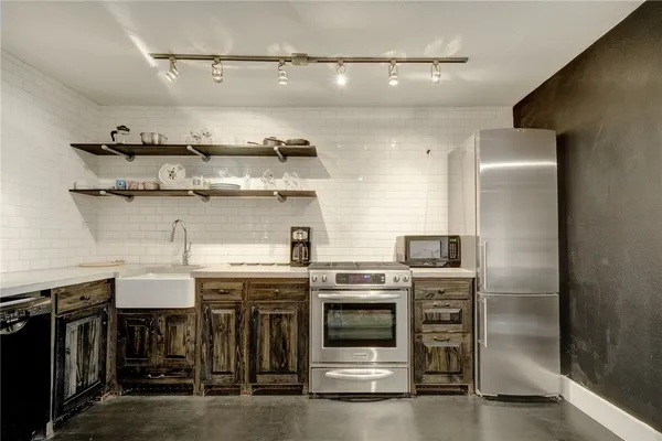 a kitchen with stainless steel appliances granite countertop a stove and a refrigerator