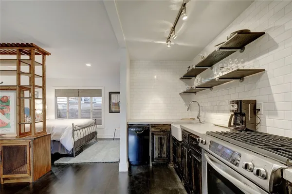 a kitchen with stainless steel appliances granite countertop a stove and a sink