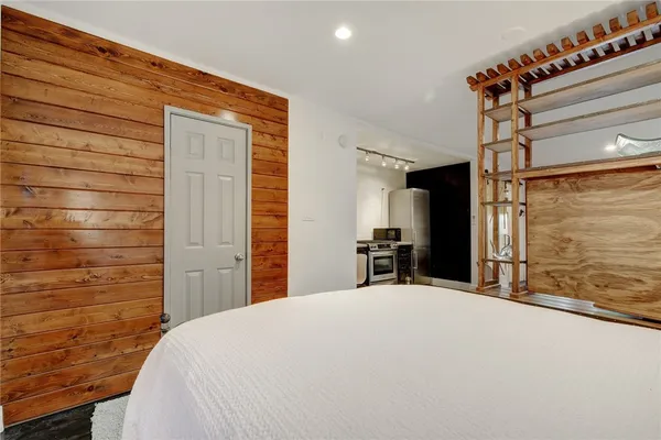 a bedroom with a bed and a flat screen tv