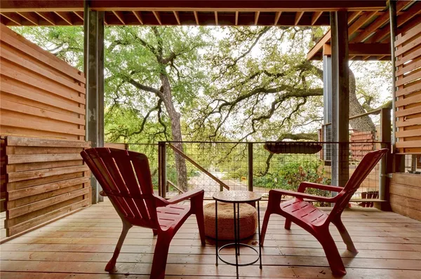 a view of a chairs and table in the balcony