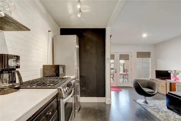 a kitchen with a stove and a refrigerator