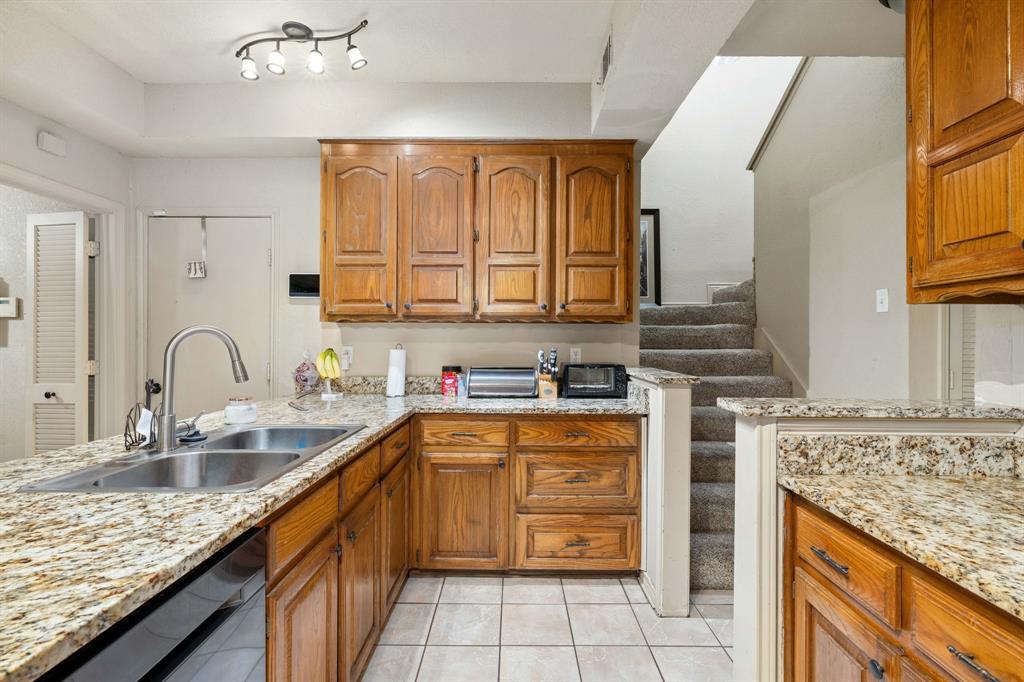 104 Pecan Grove Lancaster, TX 75146 - Photo 15 of 33 a kitchen with stainless steel appliances granite countertop a sink stove and cabinets