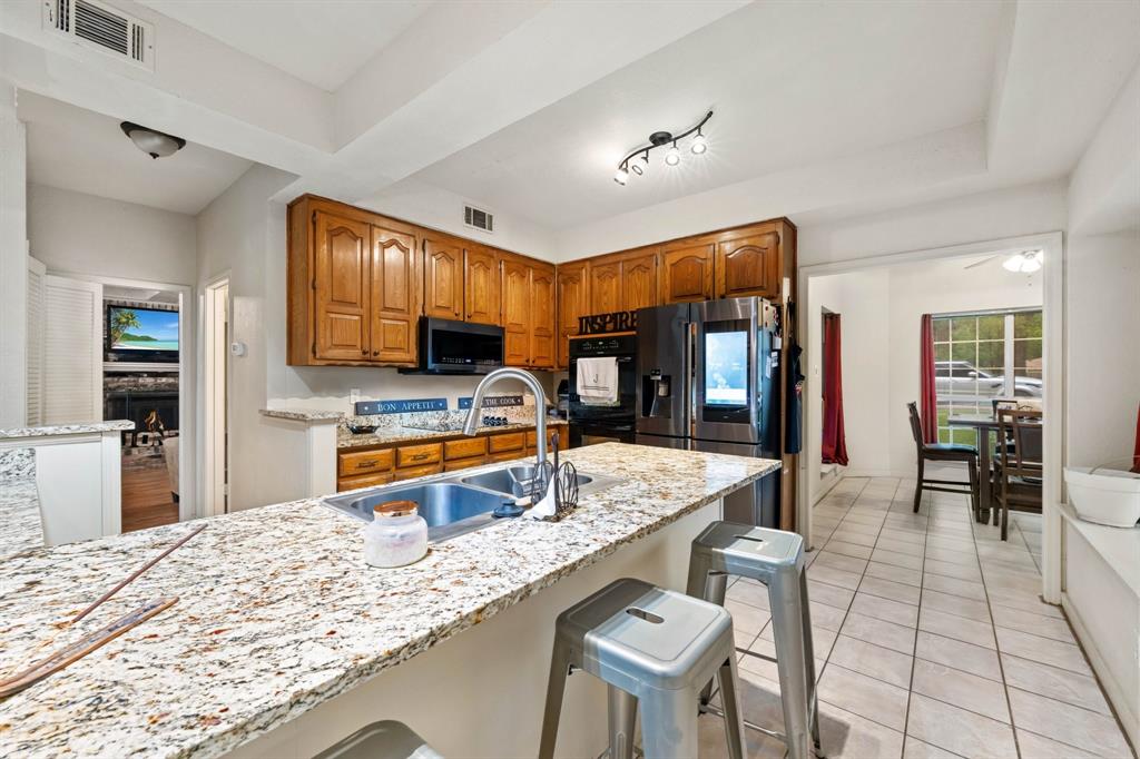 104 Pecan Grove Lancaster, TX 75146 - Photo 16 of 33 a kitchen with stainless steel appliances granite countertop a sink and counter space