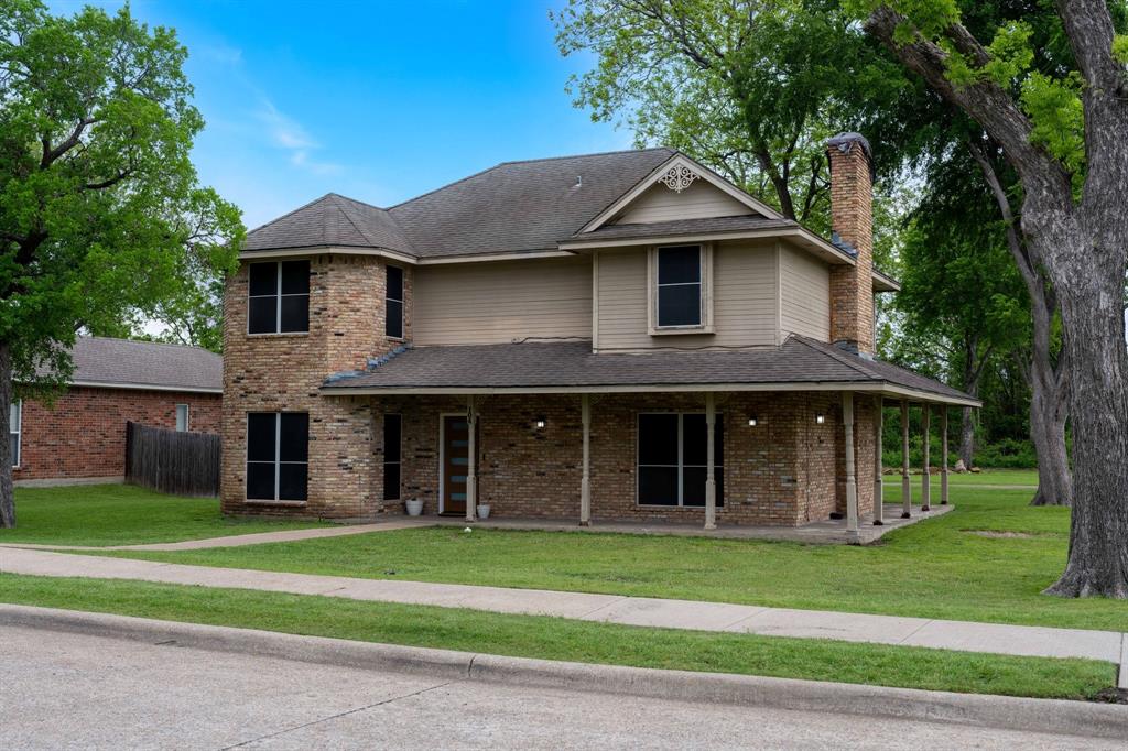 104 Pecan Grove Lancaster, TX 75146 - Photo 2 of 33 a front view of a house with a garden