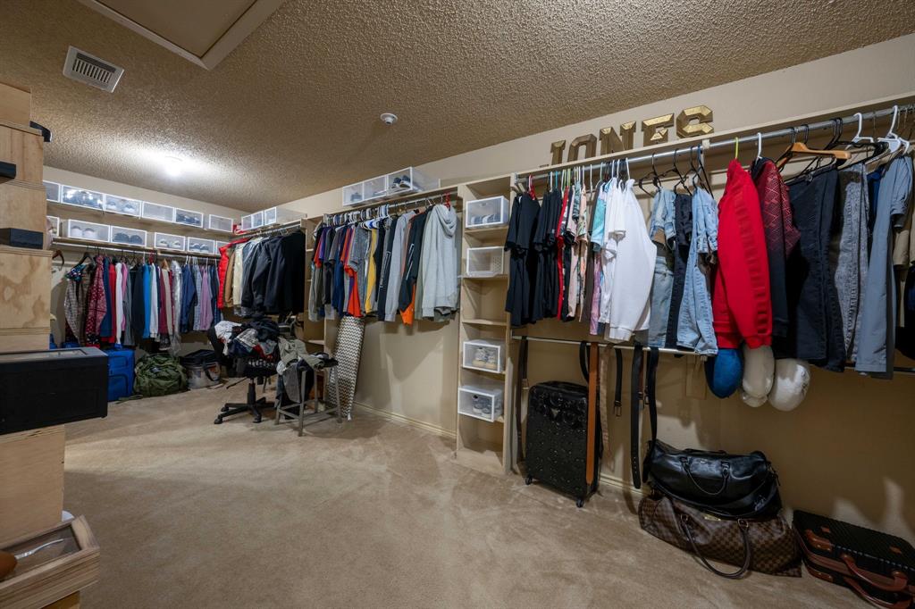 104 Pecan Grove Lancaster, TX 75146 - Photo 23 of 33 a view of walk in closet with clothes and shoes