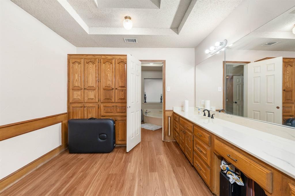 104 Pecan Grove Lancaster, TX 75146 - Photo 25 of 33 a spacious bathroom with a double vanity sink a large mirror and a shower