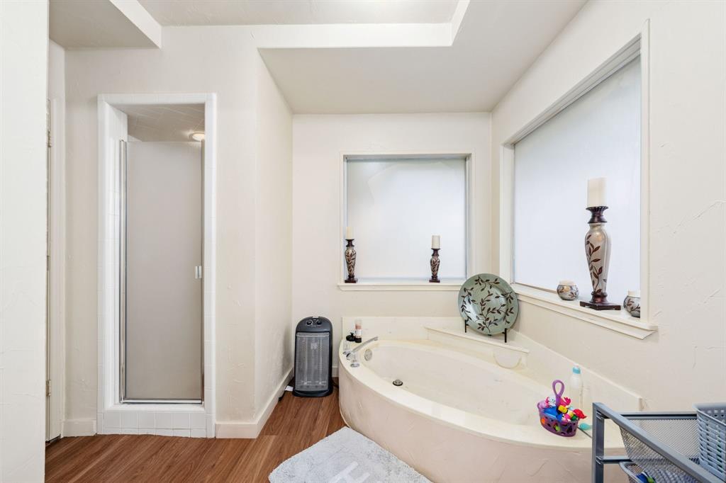 104 Pecan Grove Lancaster, TX 75146 - Photo 26 of 33 a bathroom with a tub sink and toilet