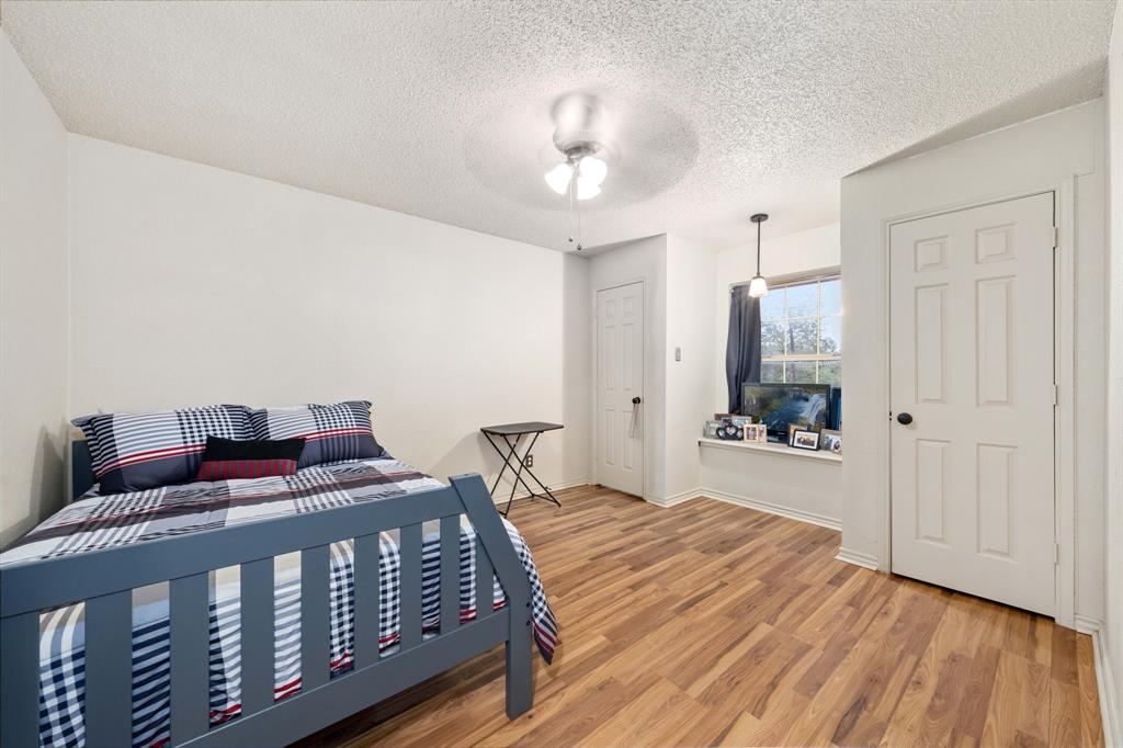 104 Pecan Grove Lancaster, TX 75146 - Photo 27 of 33 a bedroom with furniture and wooden floor