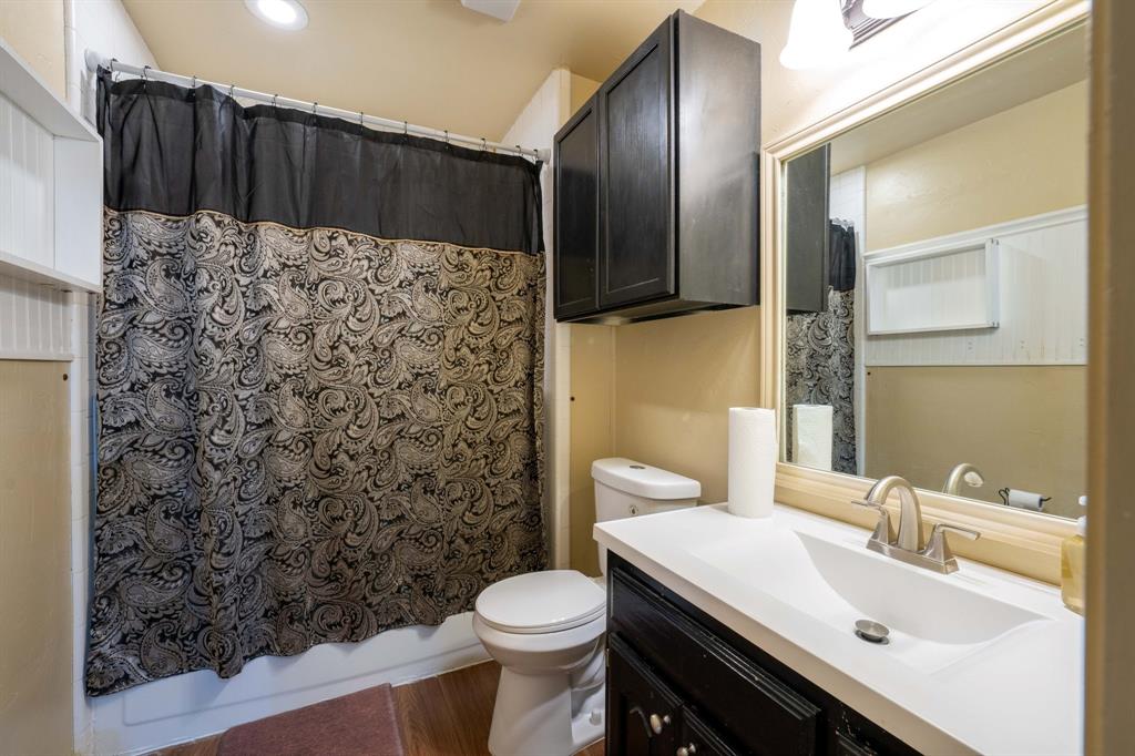 104 Pecan Grove Lancaster, TX 75146 - Photo 29 of 33 a bathroom with a sink toilet and shower