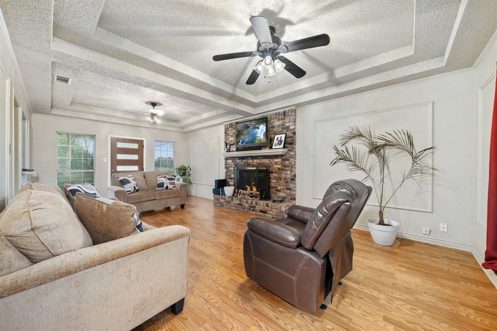 104 Pecan Grove Lancaster, TX 75146 - Photo 4 of 33 a living room with furniture a fireplace and a ceiling fan