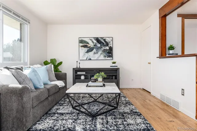 a living room with furniture and a rug