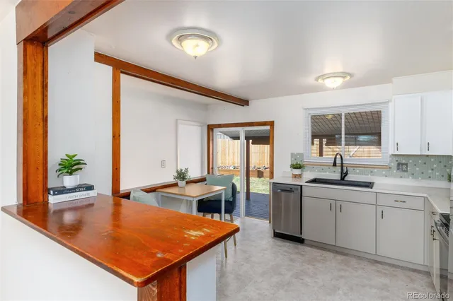 a kitchen with stainless steel appliances granite countertop sink stove and cabinets