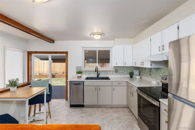 a kitchen with a sink stove and cabinets