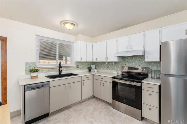 a kitchen with a sink stove and refrigerator