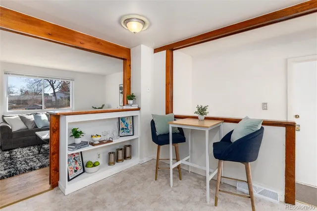 a view of a dining room with furniture and a potted plant