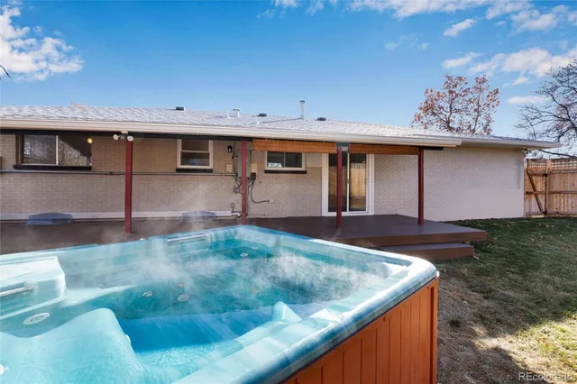 a backyard of a house with table and chairs