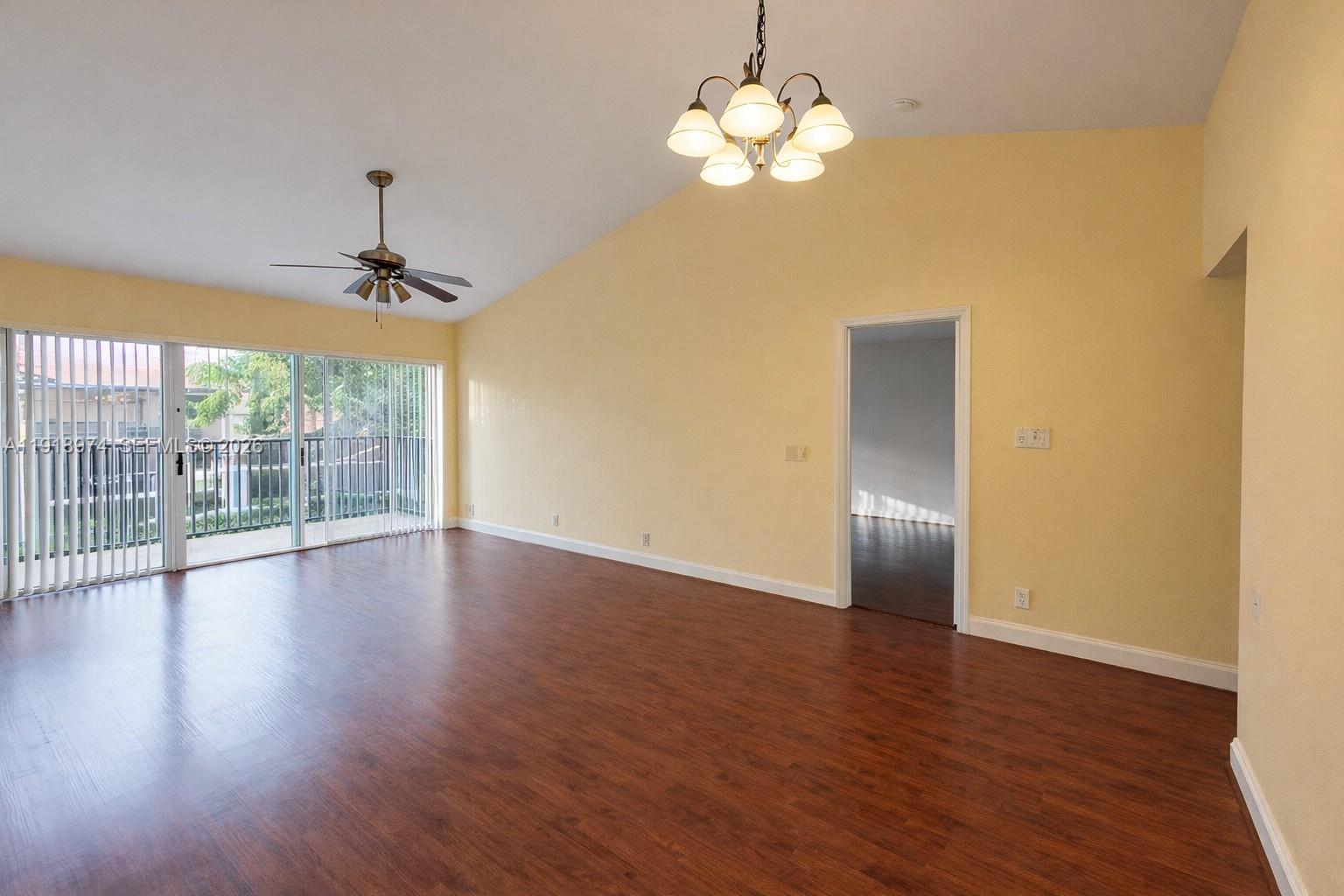 8801 Wiles Road, Unit 307 Coral Springs, FL 33067 - Photo 7 of 18 a view of empty room with wooden floor and fan