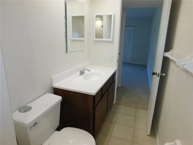 a bathroom with a sink toilet and vanity