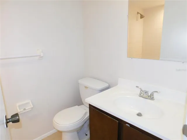 a bathroom with a sink a toilet and mirror