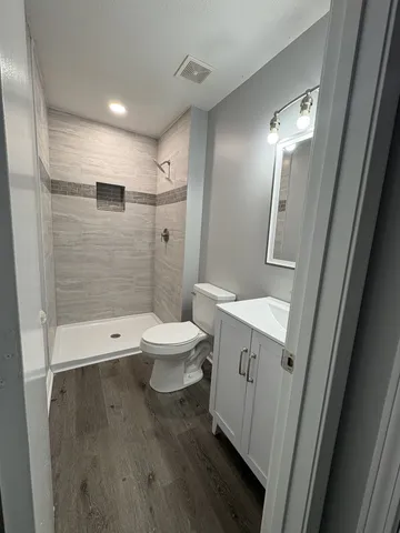 a bathroom with a toilet sink and shower