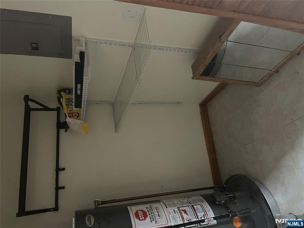 a view of storage and utility room with racks on the wall