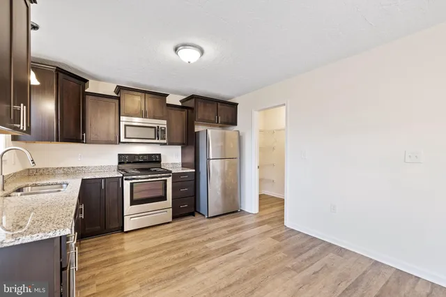 a kitchen with a refrigerator stove and sink
