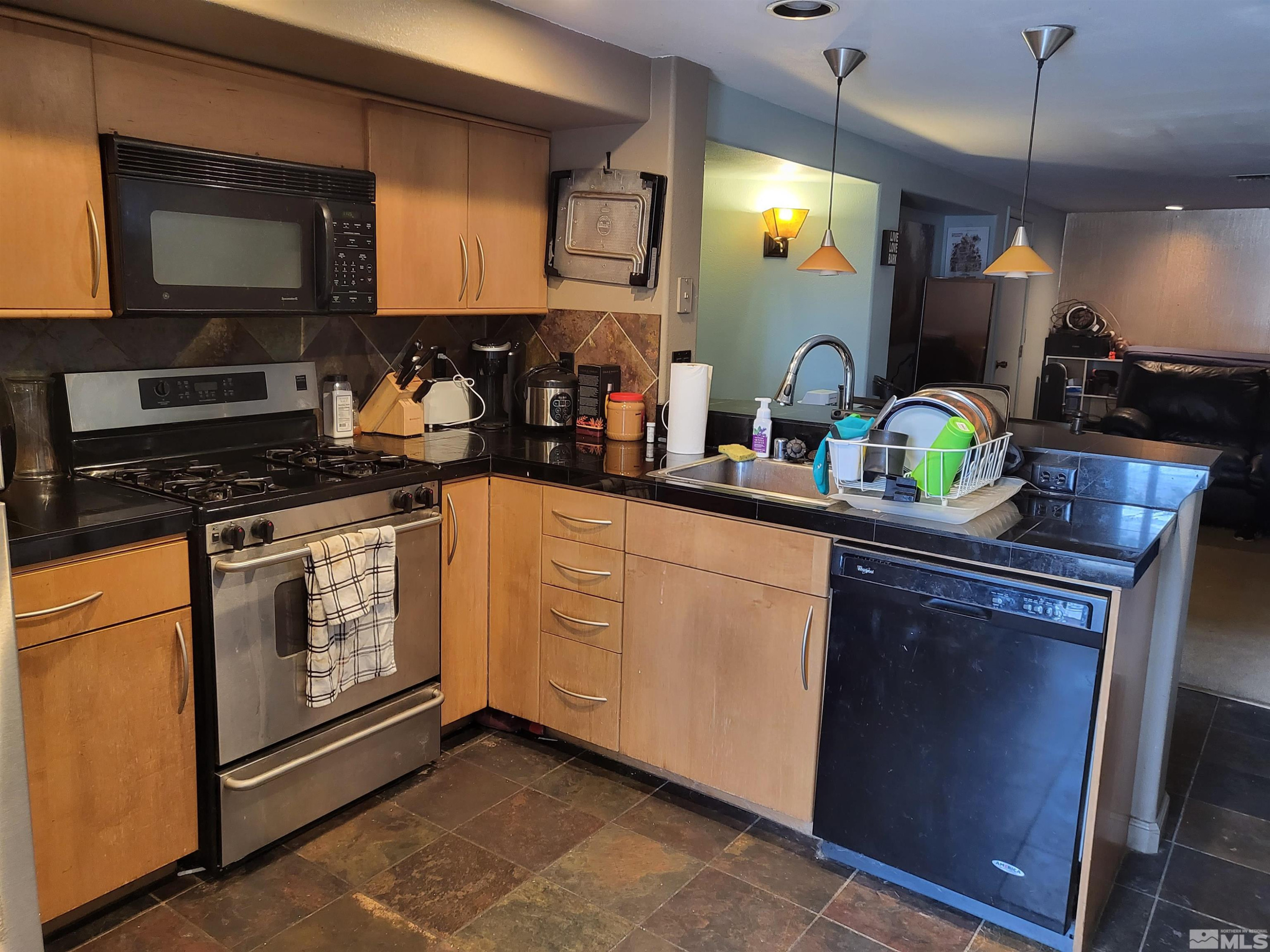 1347 Terrace Drive Reno, NV 89503 - Photo 20 of 25 a kitchen with granite countertop a sink stainless steel appliances and cabinets