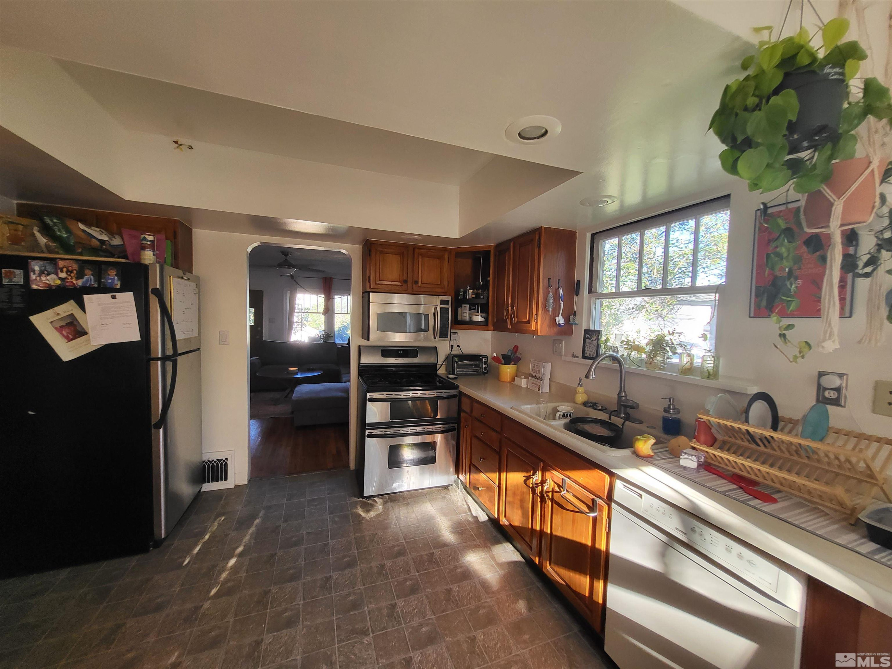 1347 Terrace Drive Reno, NV 89503 - Photo 8 of 25 a kitchen with stainless steel appliances kitchen island granite countertop a refrigerator and a sink