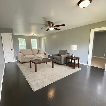 a living room with furniture and a chandelier