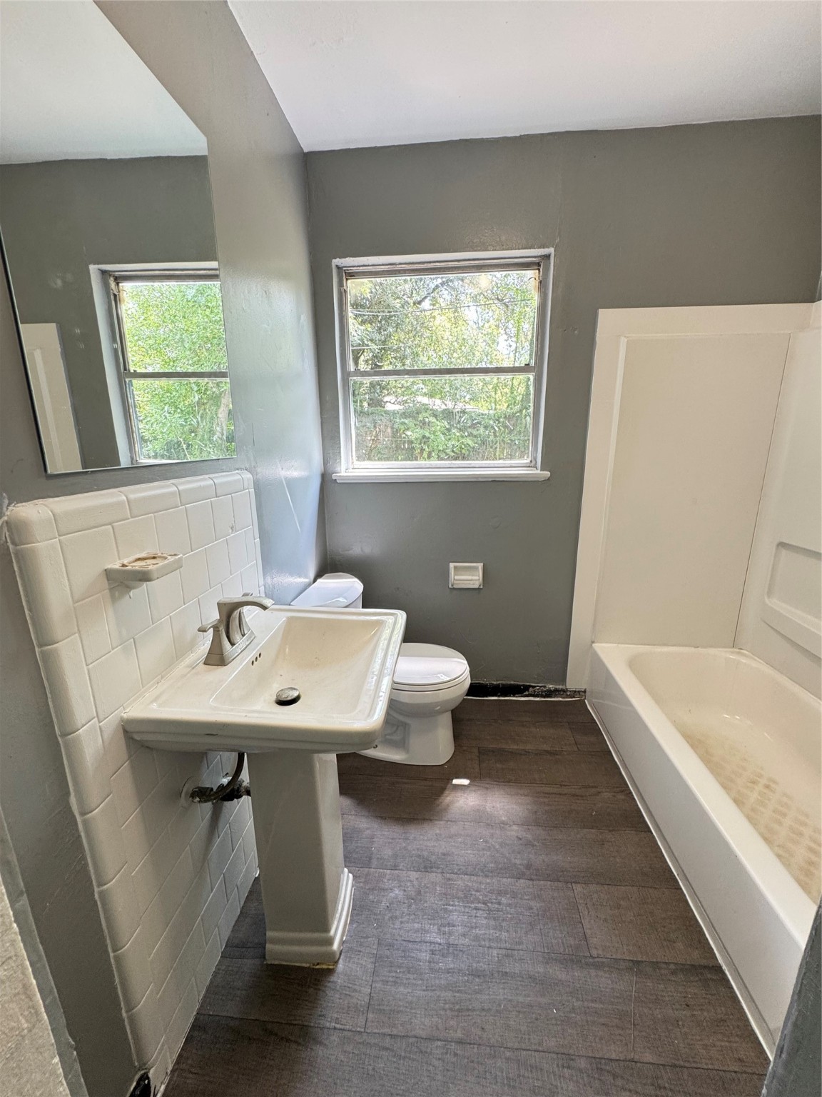 5254 Perry Street Houston, TX 77021 - Photo 8 of 16 a bathroom with a sink a bathtub and a window
