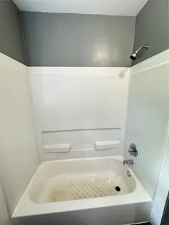 a view of a livingroom with a ceiling fan and window