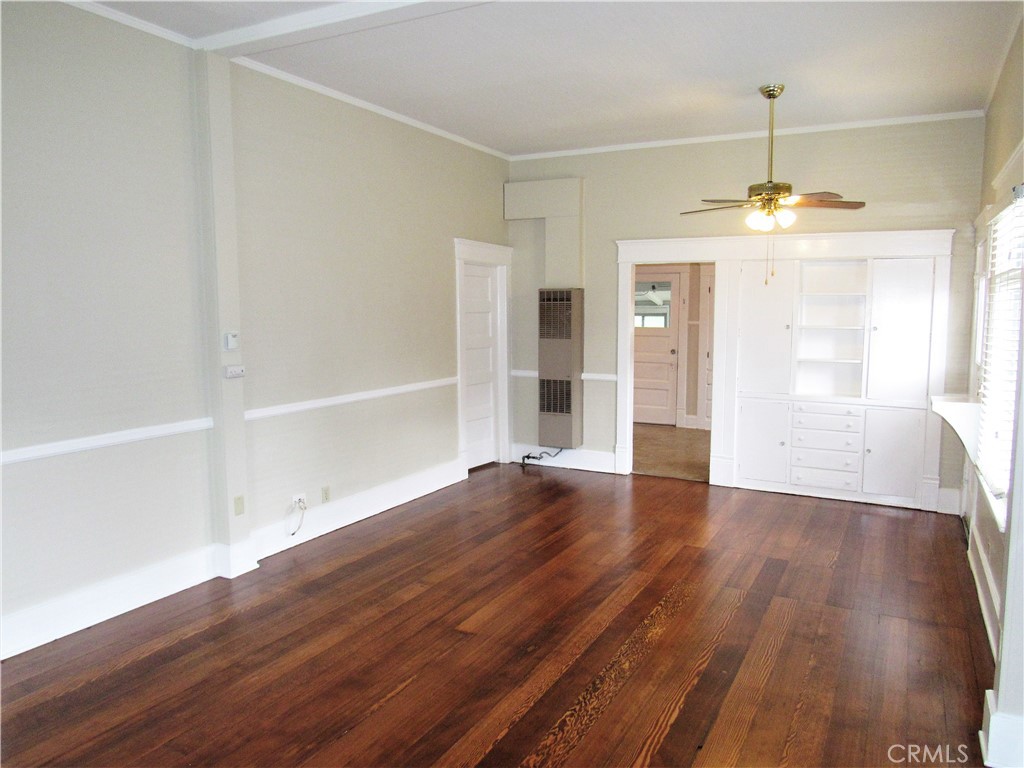 478 South Grand Street Orange, CA 92866 - Photo 3 of 10 an empty room with wooden floor and windows