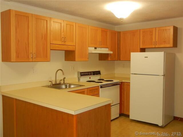 65 Old Route 79, Unit 13 Madison, CT 06443 - Photo 3 of 24 a kitchen with a sink a stove a refrigerator a counter space and cabinets