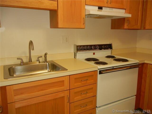 65 Old Route 79, Unit 13 Madison, CT 06443 - Photo 4 of 24 a kitchen with a sink cabinets and appliances
