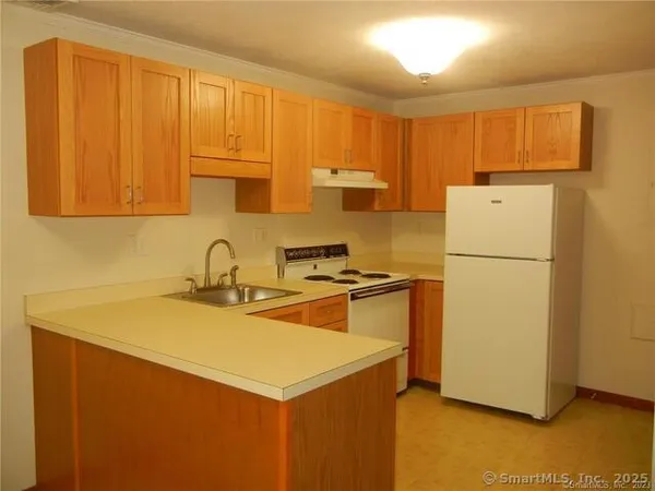 a kitchen with a sink cabinets and appliances