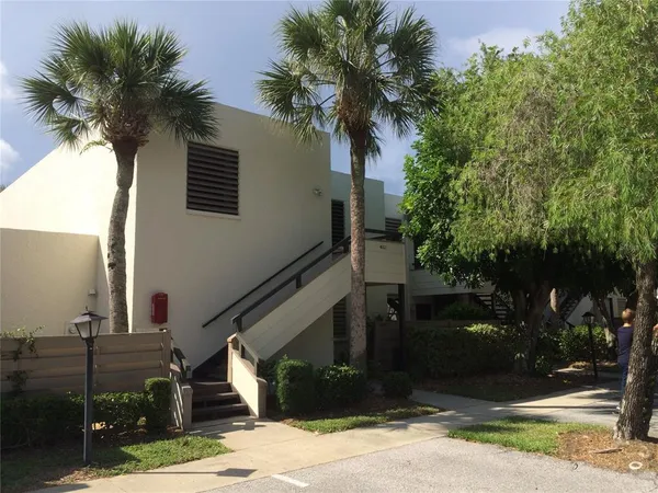 a front view of a house with tree s