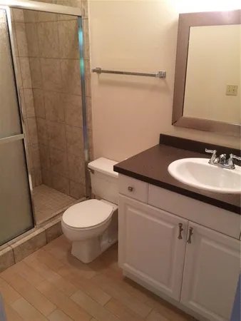 a bathroom with a sink toilet and shower