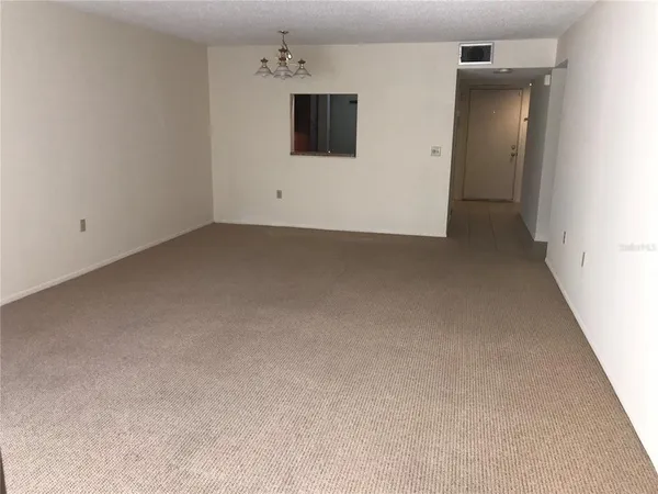 a view of kitchen and empty room