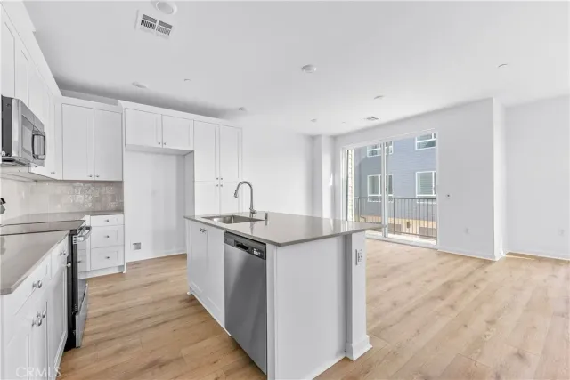 a kitchen with stainless steel appliances granite countertop a stove and a sink